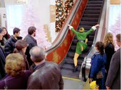 Man in elf costume climbing escalator