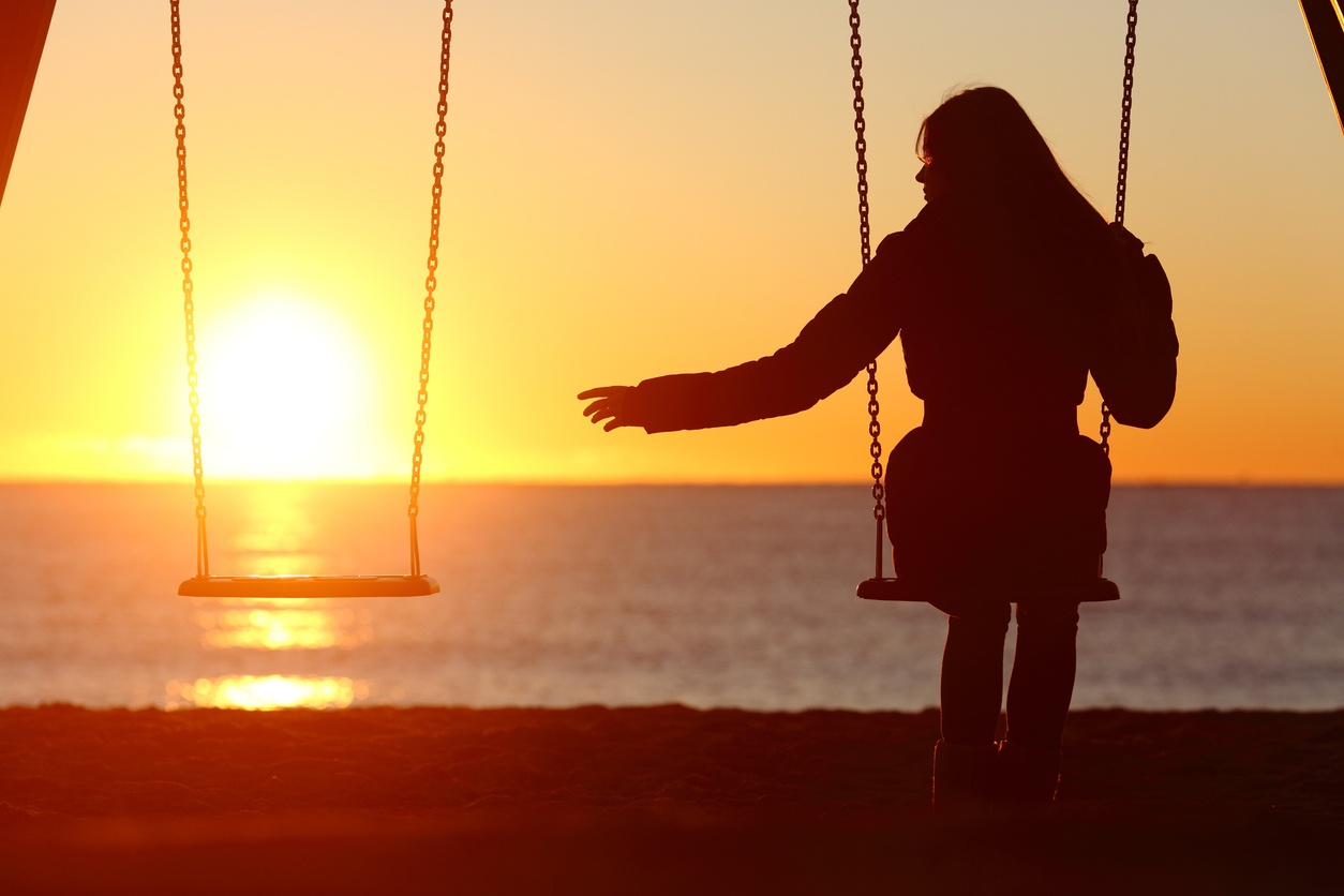 Person on swing and other swing empty